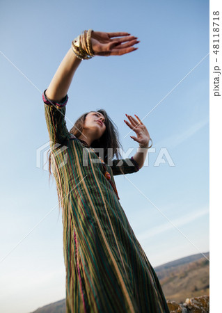 Beautiful boho woman dancing in nature 48118718