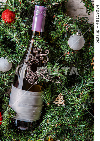 Photo of spruce branches with bottle of wine, blank greeting card 48119084