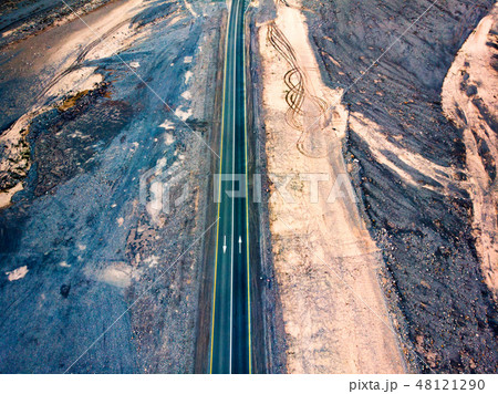 Desert road surrounded by sandstones aerial view Desert road surrounded by sandstones aerial view 48121290