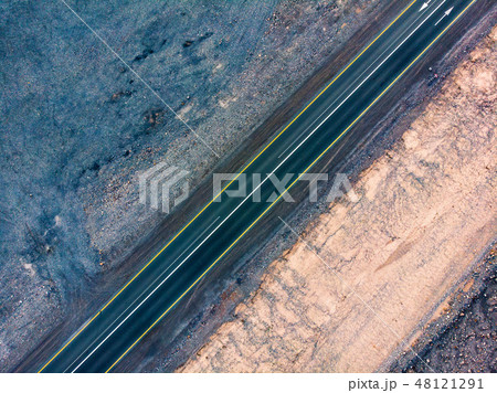 Desert road surrounded by sandstones aerial view Desert road surrounded by sandstones aerial view 48121291
