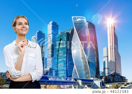 Young business woman holds glasses and looking up with inspiration Young business woman holds glasses and looking up with inspiration 48122383