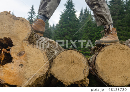 Hiker's boots on logs Hiker's boots on logs 48123720