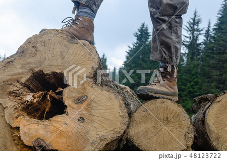 Hiker's boots on logs 48123722