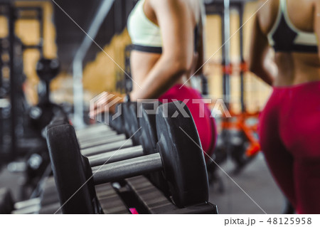 girl in the gym dumbbells 48125958