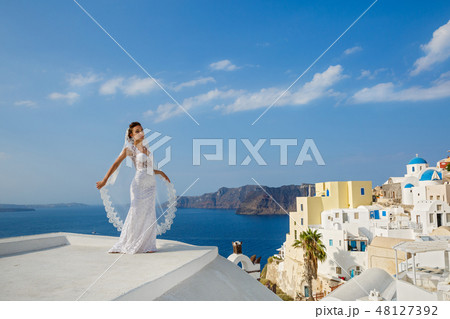 Bride in white dress on the high roof of Santorin Bride in white dress on the high roof of Santorin 48127392