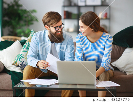 married couple bills receipts documents and laptop 48127779