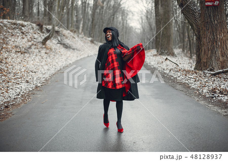 Elegant black girl in a winter park Elegant black girl in a winter park 48128937