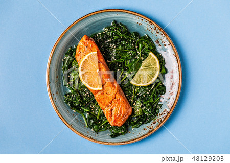 Grilled salmon with spinach. Grilled salmon with spinach. 48129203