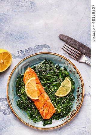 Grilled salmon with spinach. 48129207