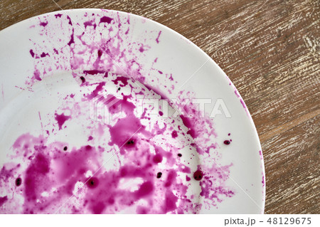 Splashes of juice of red pitahaya on white plate Splashes of juice of red pitahaya on white plate 48129675