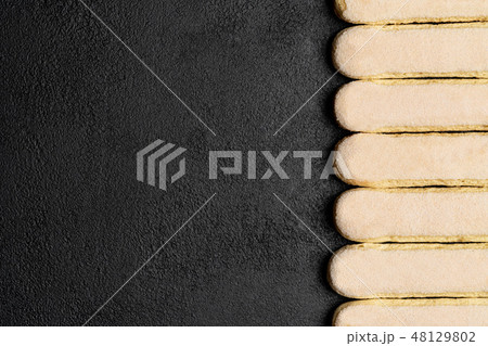 Italian Savoiardi ladyfingers Biscuits on dark concrete backgound 48129802