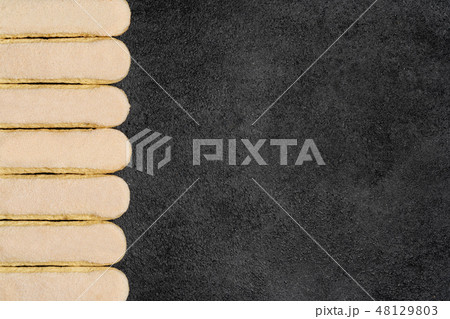 Italian Savoiardi ladyfingers Biscuits on dark concrete backgound 48129803
