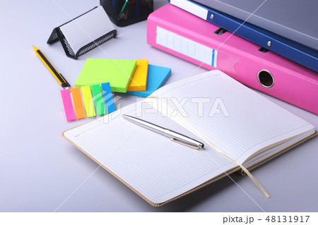 Folder file, note, pen and watch on the desk. blurred background. 48131917