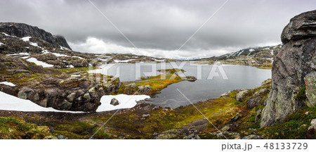 Typical norwegian landscape with snowy mountains Typical norwegian landscape with snowy mountains 48133729