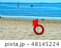 red flag with a lifebuoy on the beach 48145224