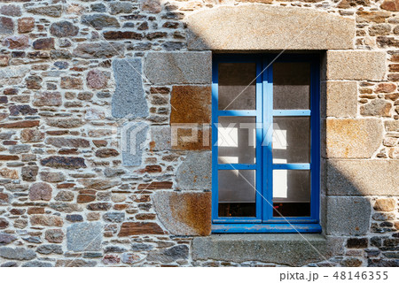 Blue window on stone wall in village in Brittany Blue window on stone wall in village in Brittany 48146355