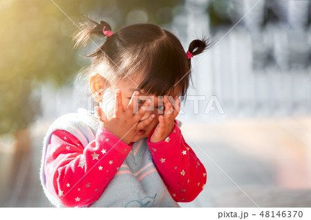 asian girl closing her face and playing peekaboo 48146370