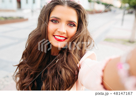 Beautiful brunette with red lips and wavy hair Beautiful brunette with red lips and wavy hair 48147167