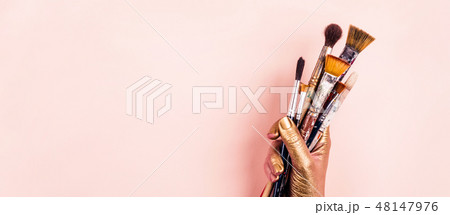 Female Artist golden hand with set of brushes. Banner format Female Artist golden hand with set of brushes. Banner format 48147976