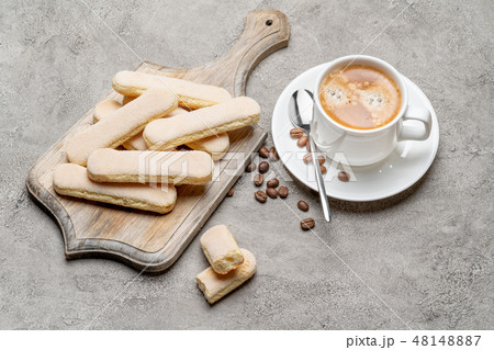 Italian Savoiardi ladyfingers Biscuits and cup of coffee on concrete backgound 48148887