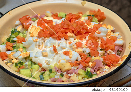 Sliced vegetables and boiled eggs in a yellow bowl Sliced vegetables and boiled eggs in a yellow bowl 48149109