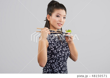 Sushi woman holding sushi with chopsticks 48150571