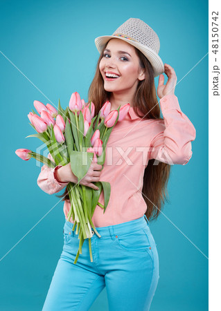 Young beautiful woman studio portrait with tulip flowers Young beautiful woman studio portrait with tulip flowers 48150742