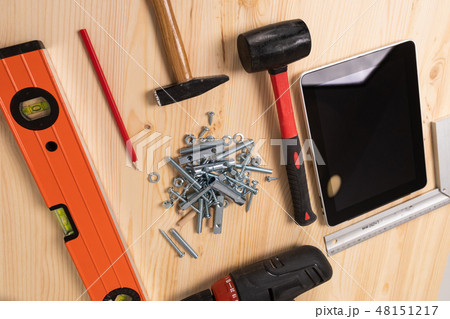 construction tool and a digital tablet lie on a light wooden table construction tool and a digital tablet lie on a light wooden table 48151217