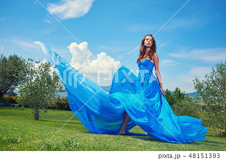 woman in blue dress on Tuscany hills 48151393