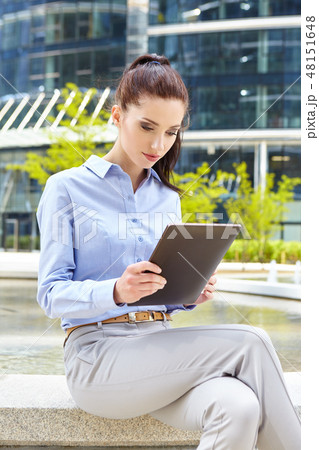 businesswoman with a disposable coffee cup and tablet businesswoman with a disposable coffee cup and tablet 48151648