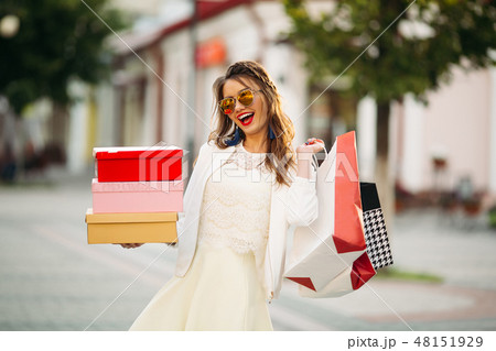 Trendy girl in sunglasses with shoe boxes and Trendy girl in sunglasses with shoe boxes and 48151929