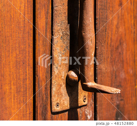 Door with brass knocker in the shape of a leg 48152880