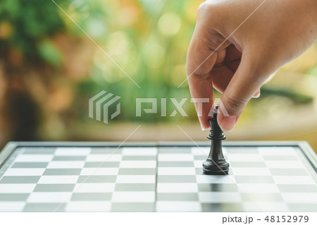 Businessman holding a King Chess is placed on 48152979