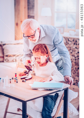 Old man helping kid watching in microscope 48155063