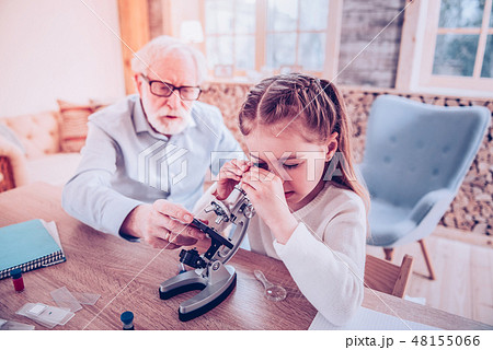 Personal teacher explaining how watching in microscope Personal teacher explaining how watching in microscope 48155066