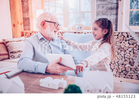 Old man laughing with his cute granddaughter 48155123