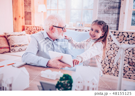 Young lady showing grandfather how taking picture at phone 48155125