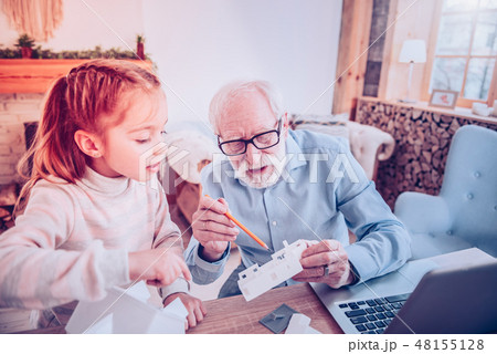 Old man showing kid how doing home Old man showing kid how doing home 48155128