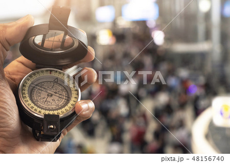 holding compass on blurred background holding compass on blurred background 48156740