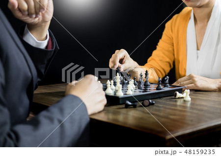 hand of businessman moving chess figure in competition board gam 48159235