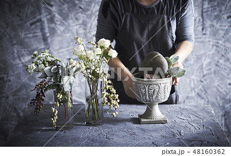 フラワーアレンジメントとする女性 48160362