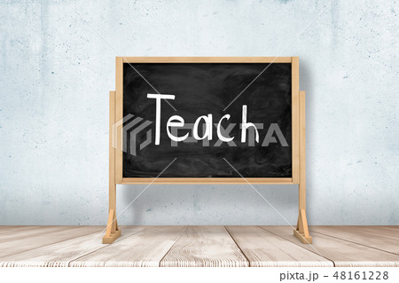 3d rendering of school blackboard with 'TEACH' chalk sign on white wooden floor and white wall 48161228