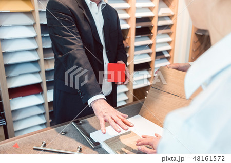 Kitchen expert showing people in his showroom materials and colors 48161572