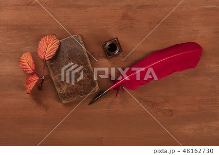 Autumn Poetry. A photo of an old book with a thorny branch with vibrant leaves, an ink well, and a Autumn Poetry. A photo of an old book with a thorny branch with vibrant leaves, an ink well, and a 48162730