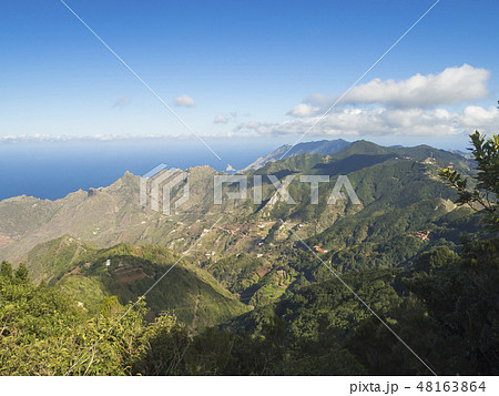 view point Amogoje, green hills with rock in the sea El Draguillo in anaga mountain, tenerife canary view point Amogoje, green hills with rock in the sea El Draguillo in anaga mountain, tenerife canary 48163864