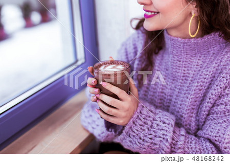 Smiling positive girl with yellow earrings and purple lipstick 48168242