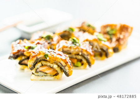 Grilled eel or unagi fish sushi maki roll with sweet sauce Grilled eel or unagi fish sushi maki roll with sweet sauce 48172885