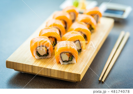 Salmon fish meat sushi roll maki on wood plate Salmon fish meat sushi roll maki on wood plate 48174078