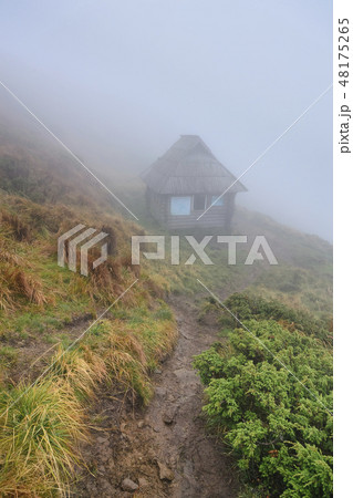 Hut in fog on hill in Chornohora, Ukraine 48175265