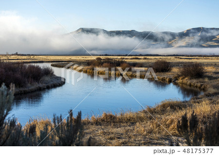 River and mountain under fog in Picabo, Idaho River and mountain under fog in Picabo, Idaho 48175377